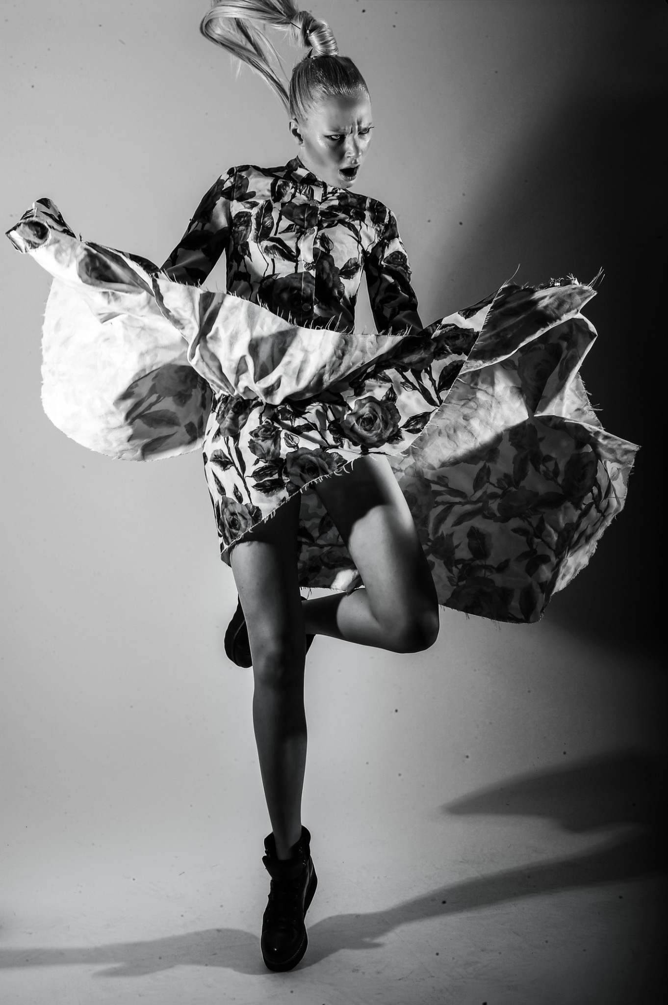 Avant-garde monochrome fashion portrait with sculptural floral dress