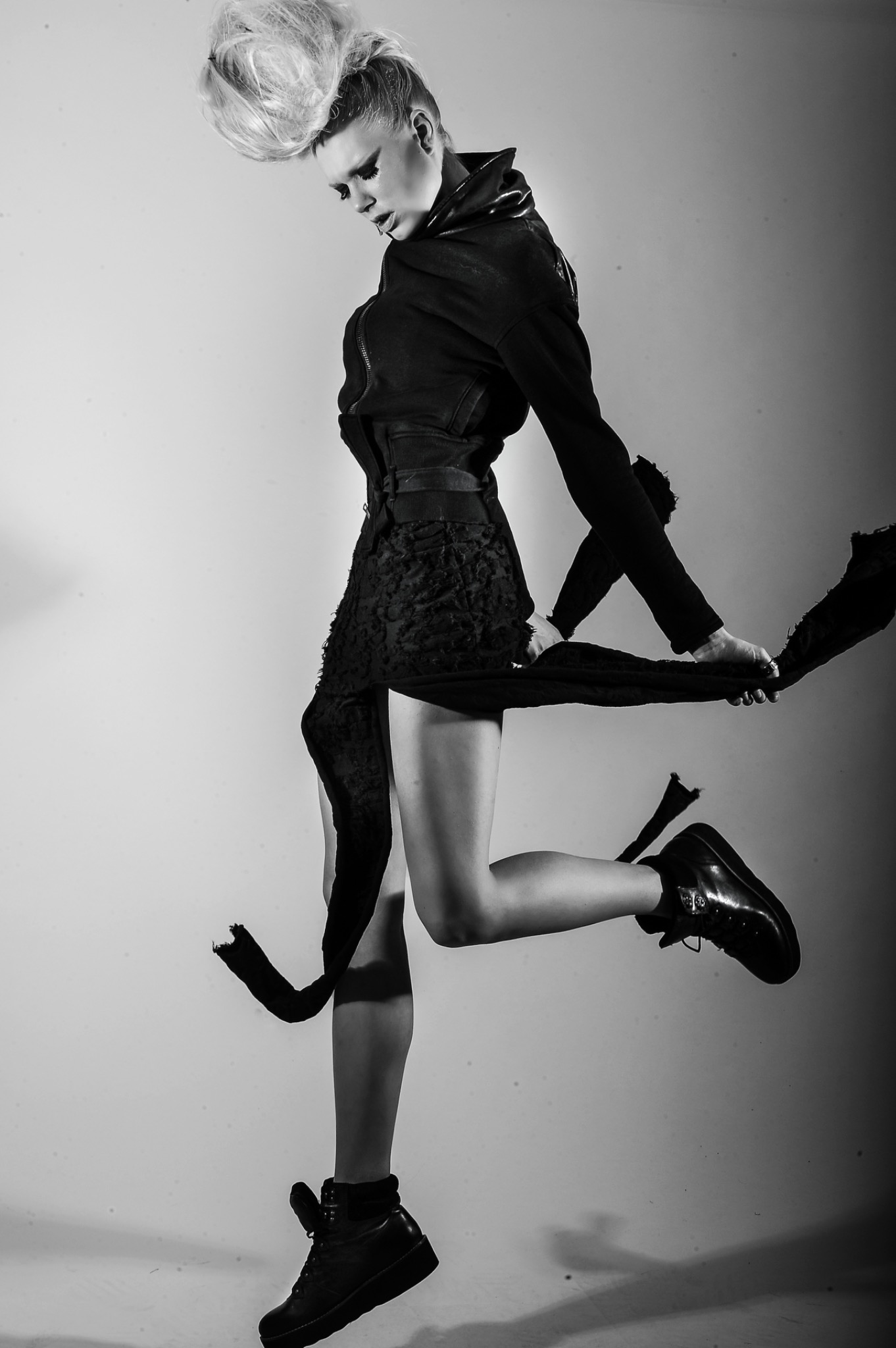 Black-and-white fashion portrait with dramatic corseted silhouette